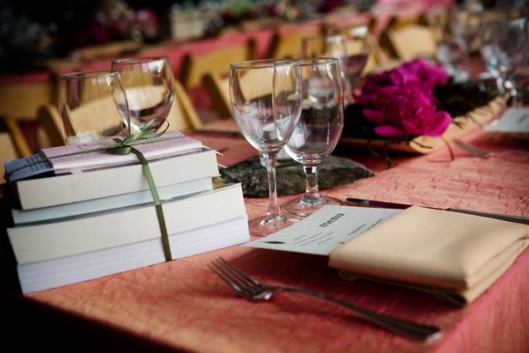 Gorgeous tables decorated with books, moss and peonies.